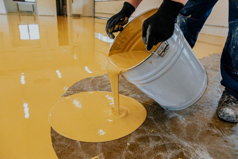 Contractor Applying Epoxy Resin To Commercial Flooring